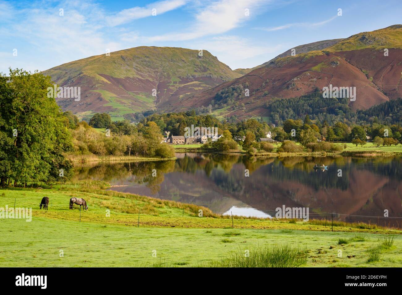 a small fishing boat on the lake at Grasmere in Cumbria England Stock Photo