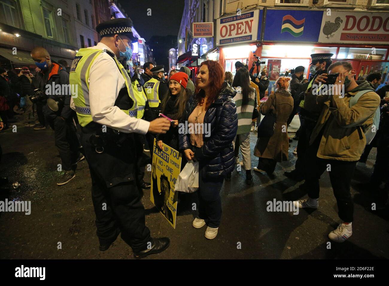 Police dispersing a gathering on the corner of Old Compton Street and Frith Street, London, on the last night before the city is put into Tier 2 restrictions to curb the spread of coronavirus. Stock Photo