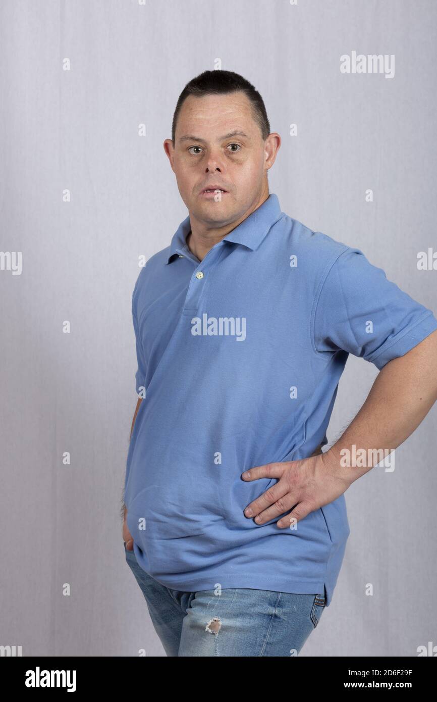 Happy man with Down syndrome in a white background photo studio wearing