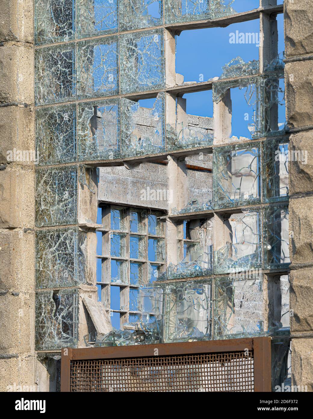 Shattered block glass windows and stone wall of the abandoned Joliet State Prison in Joliet, Illinois Stock Photo