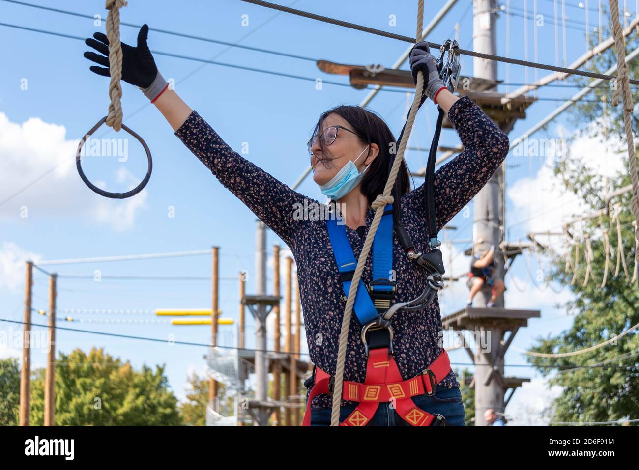 Woman, 44 years old, is climbing in a climbing park Stock Photo