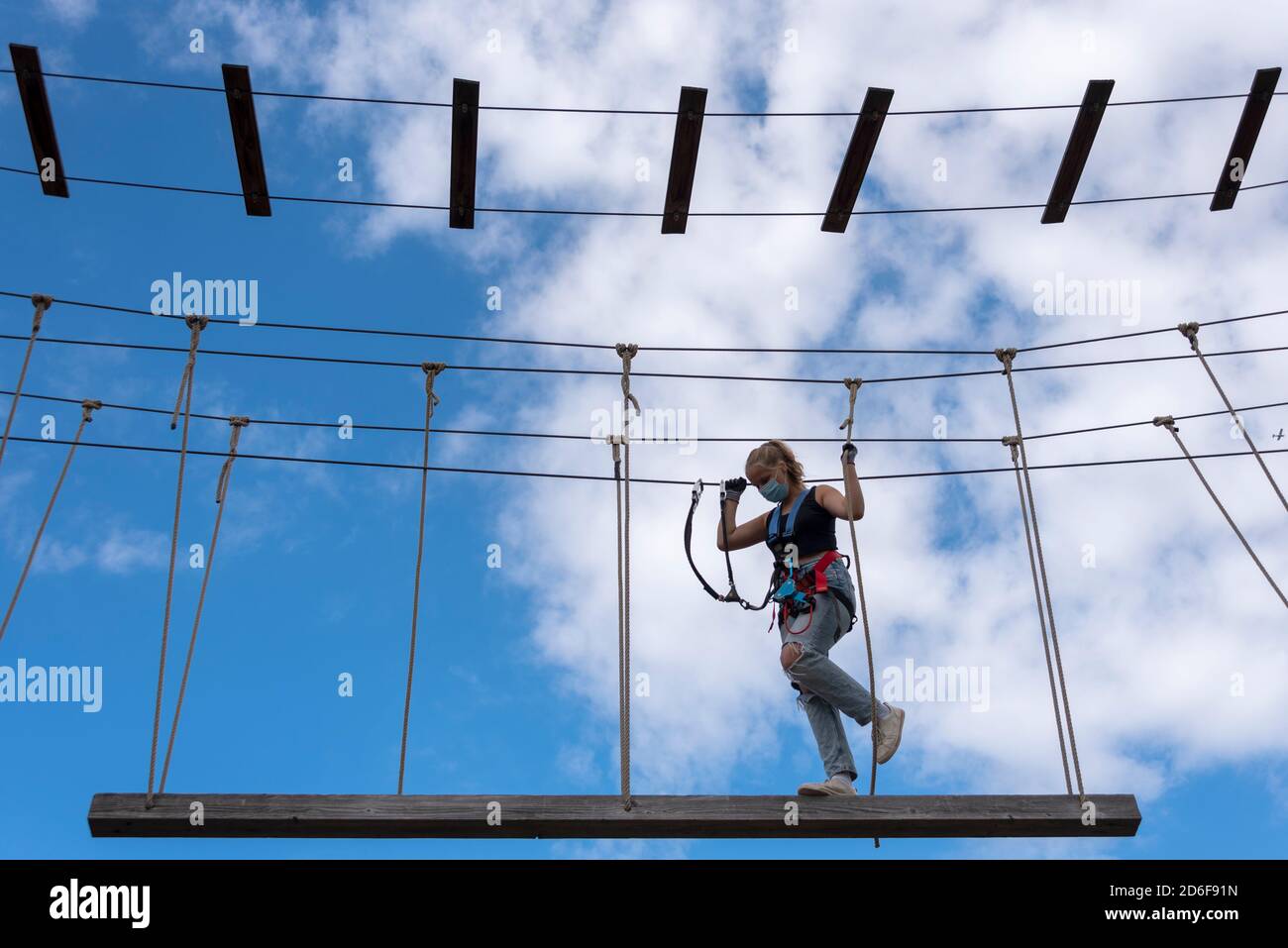 Girl, 13 years, climbs in a climbing park Stock Photo