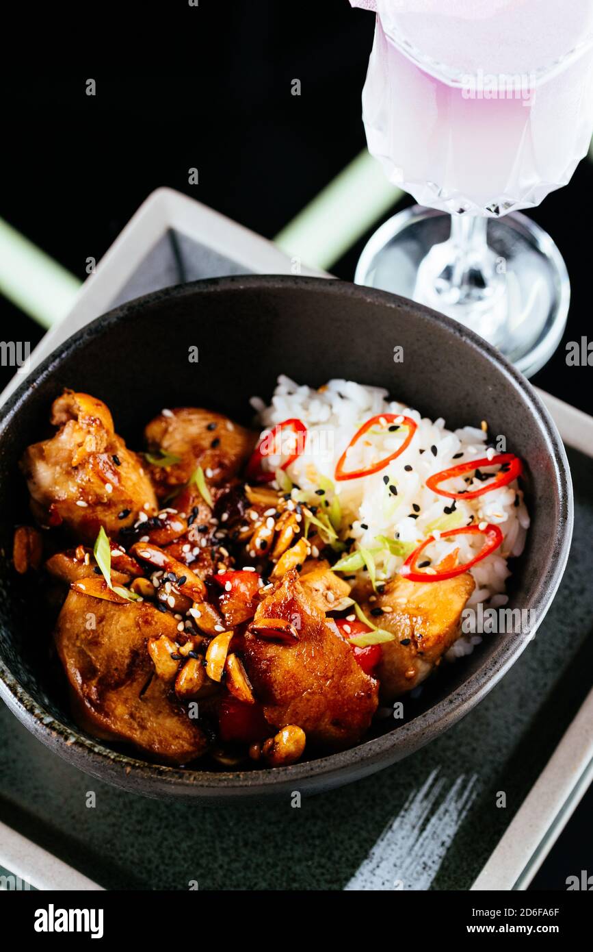Asian style chicken wings with rice on a black background Stock Photo