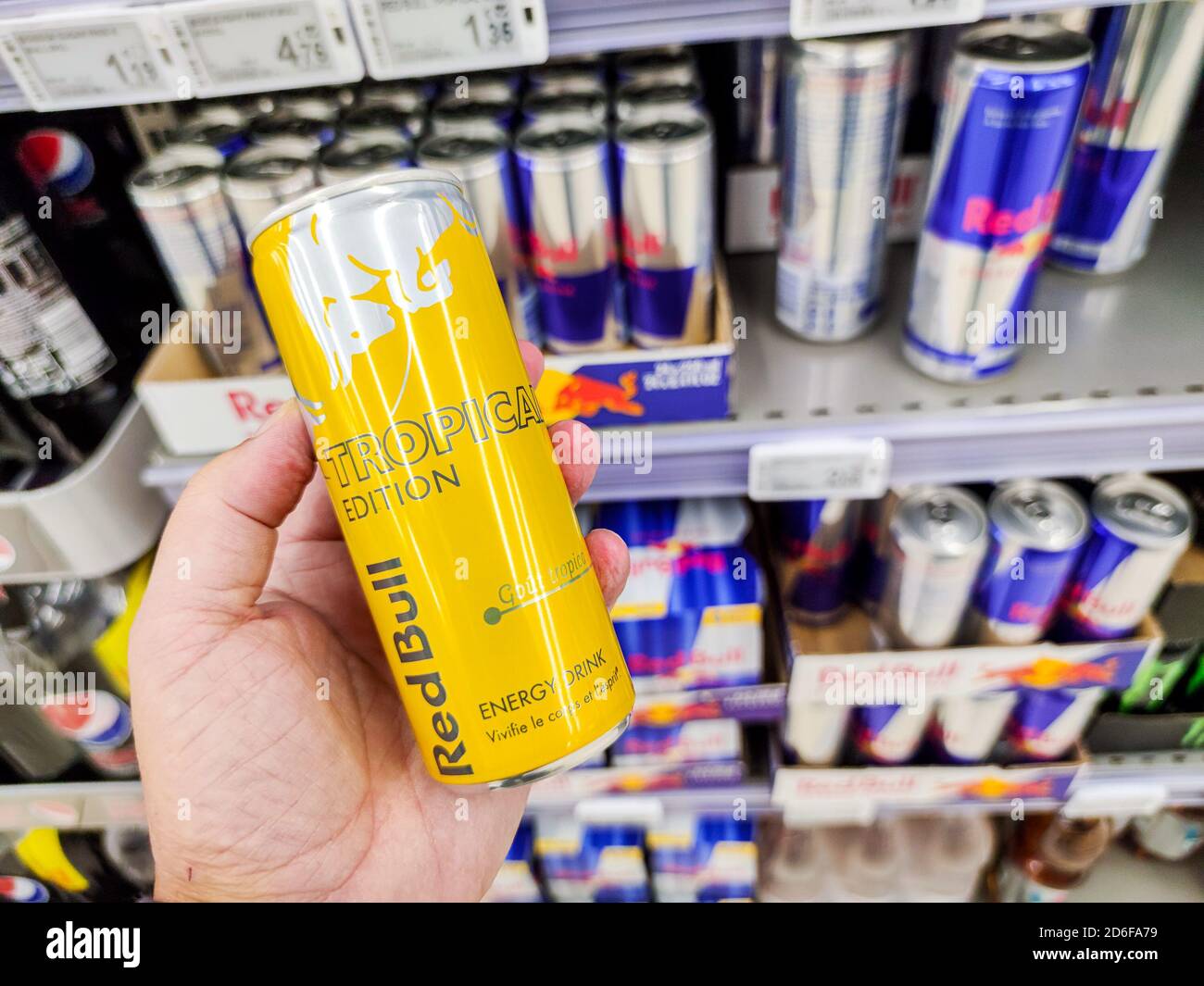 Puilboreau, France - October 14, 2020:Selected Focus on Cans of Red Bull Energy Drink Tropical edition display for sell in the supermarket shelves. Re Stock Photo