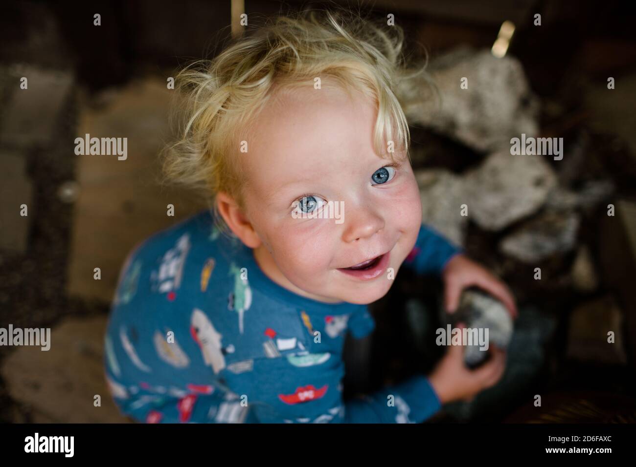 Two Year Old Holding Rock Smiling for Camera Stock Photo