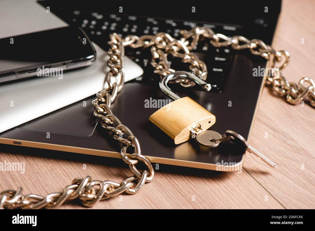 laptop with chain and unlocked padlock, computer and data security concept. Stock Photo