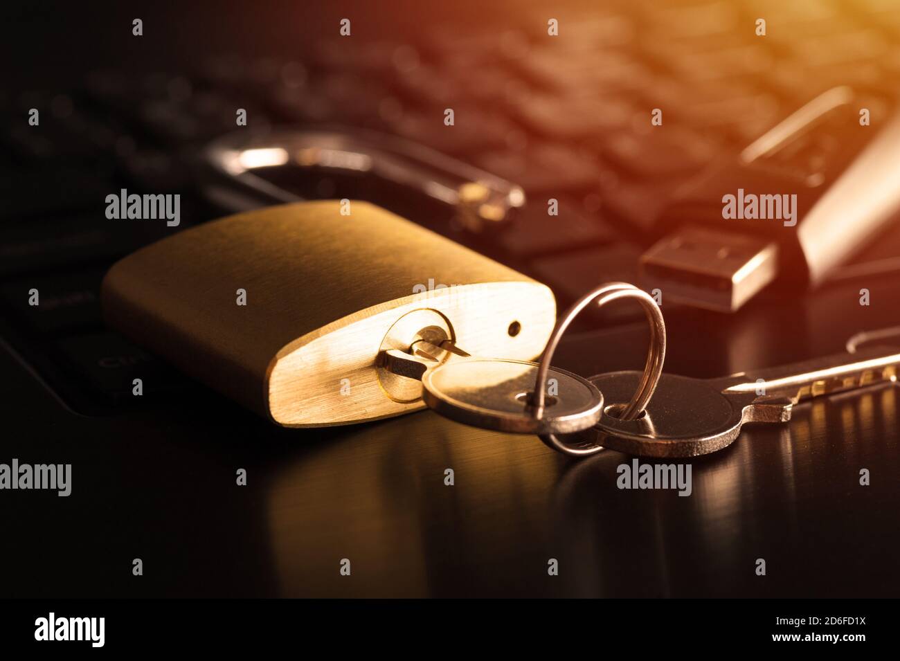 unlocked padlock on the laptop's keyboard, computer and data security concept. Stock Photo