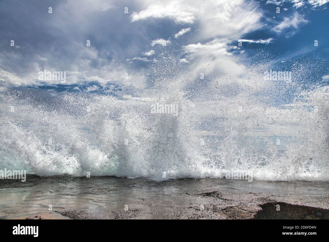 Spectacular dislay of the force of nature as a wave breaks against the pier at Olawalu Landing. Stock Photo