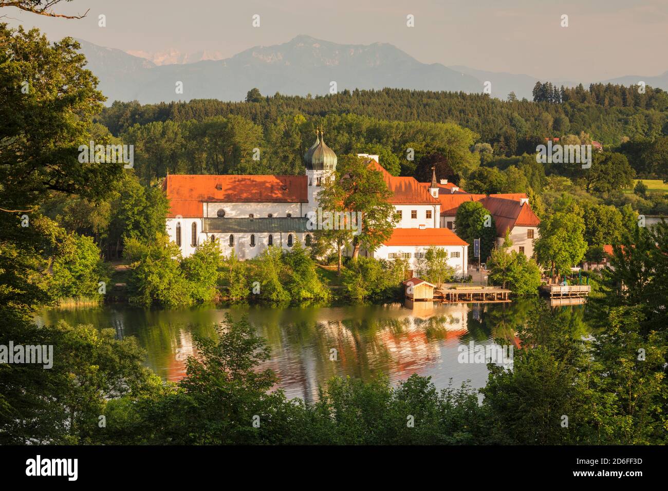 Seeon Abbey on Seeoner See at sunset, Chiemgau, Upper Bavaria, Germany Stock Photo