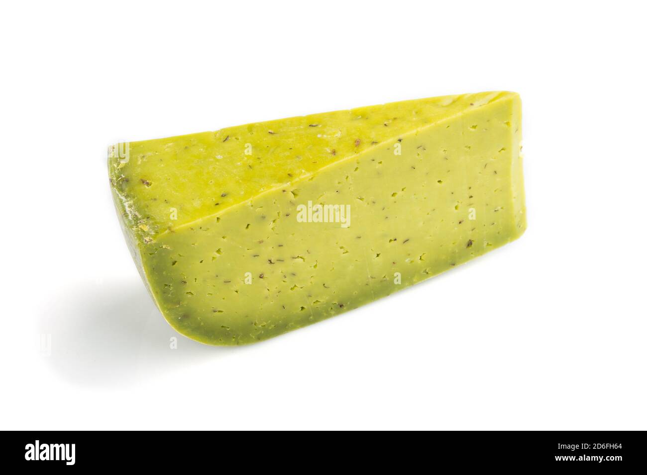 Piece of green cheese with basil isolated on white background. Side ...
