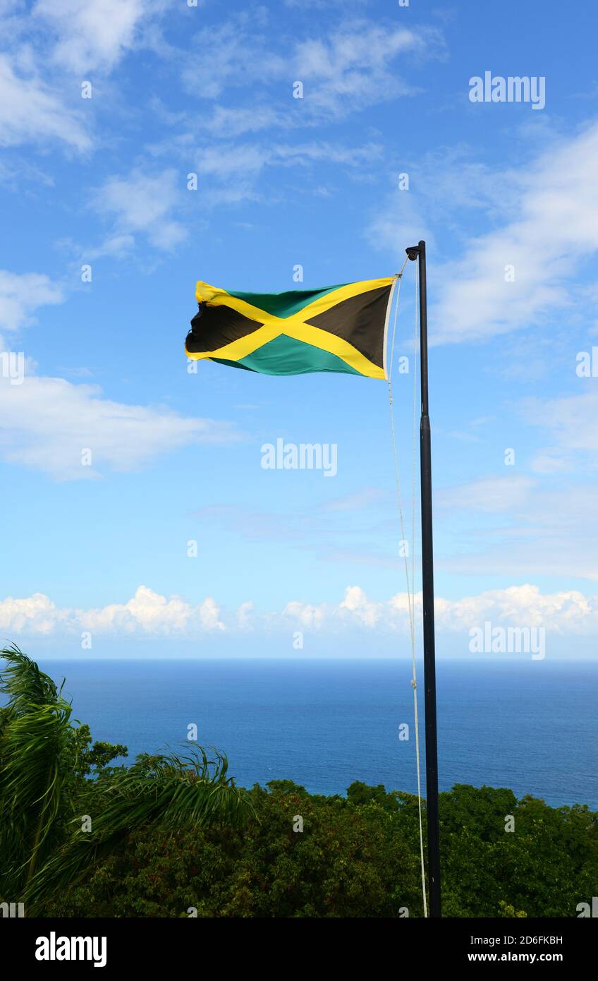 Flag Of Jamaica Waving Against Blue Sky Flag Of Jamaica Have A Gold