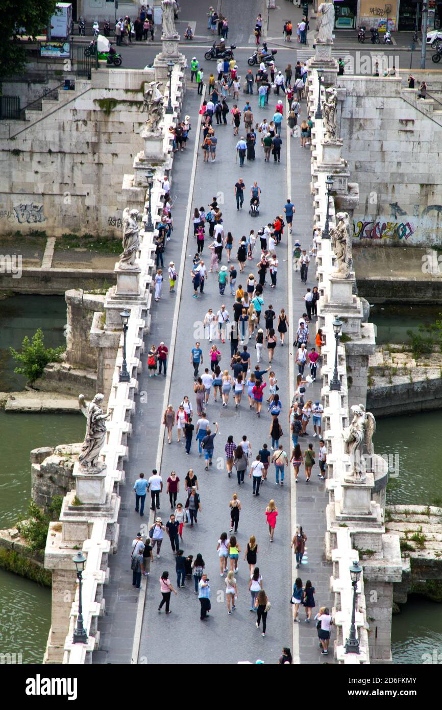 People crossing the Ponte San'Angelo bridge across the Tiber River in Rome Italy Stock Photo