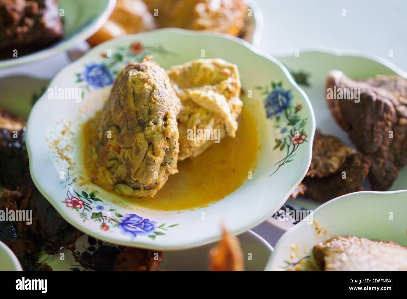 a portrait of beef brain food on a plate in a traditional food dish