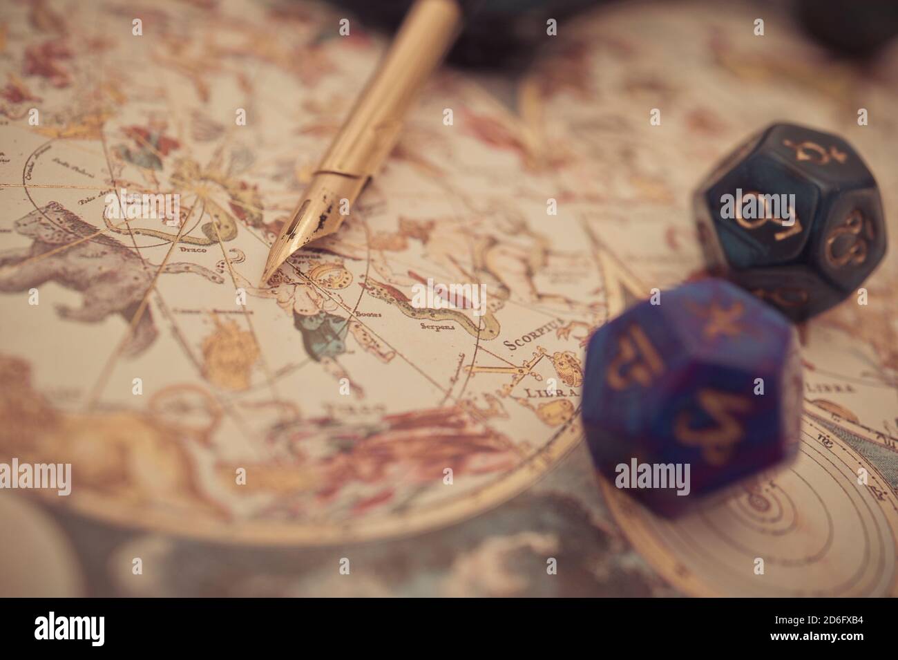 antique astrology chart with zodiac signs and dice with a quill pen