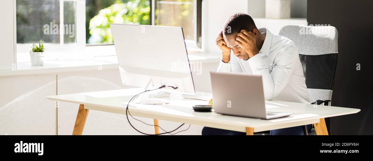 African Business Man Unhappy And Stressed At Work Stock Photo