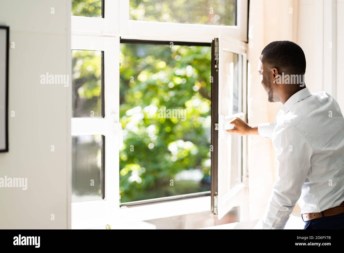 Fresh Air From Window. Side View Of Man Relaxing Stock Photo