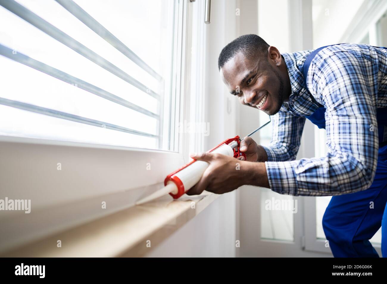 Caulk Sealant Application. Silicone Window Seal And Waterproofing Stock Photo