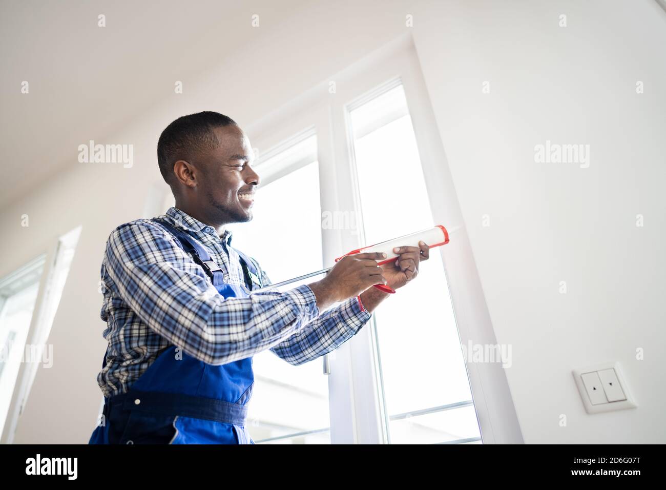 Caulk Sealant Application. Silicone Window Seal And Waterproofing Stock Photo