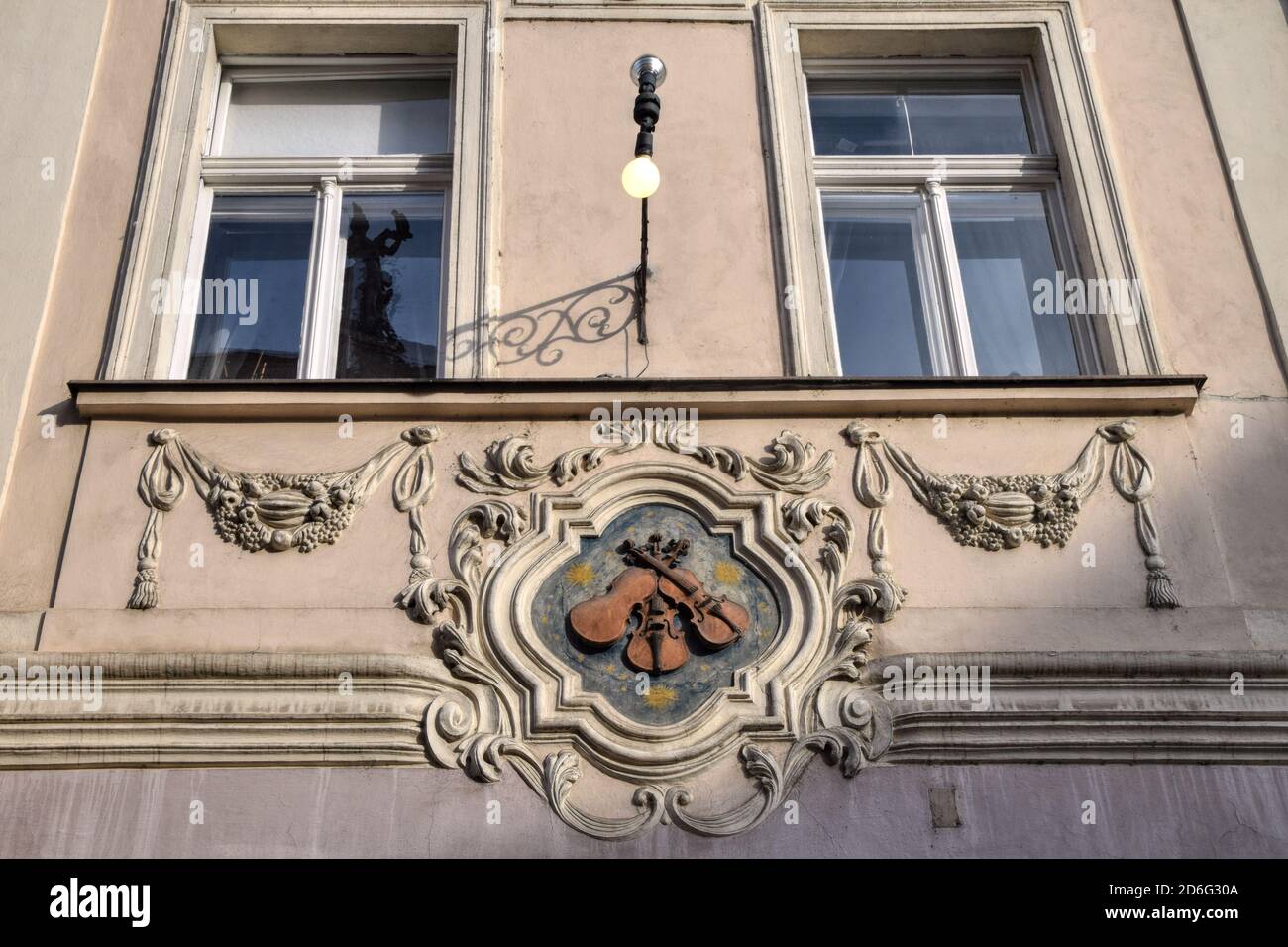 The House Sign of Old Prague in the Czech Republic - House at the Three Little Fiddles, originally a Gothic building, rebuilt in Renaissance style. Stock Photo