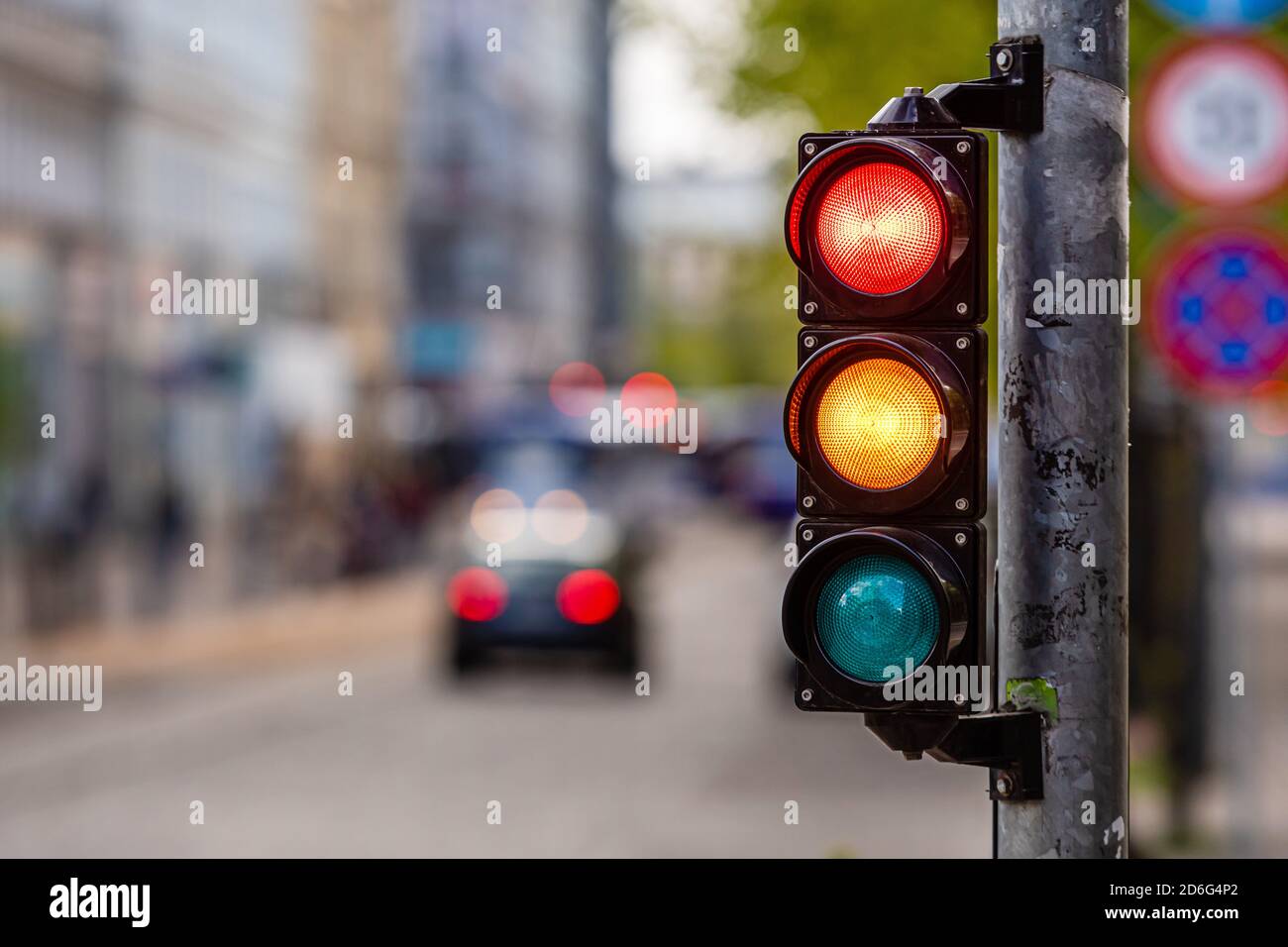 a city crossing with a semaphore, red and orange light in semaphore ...