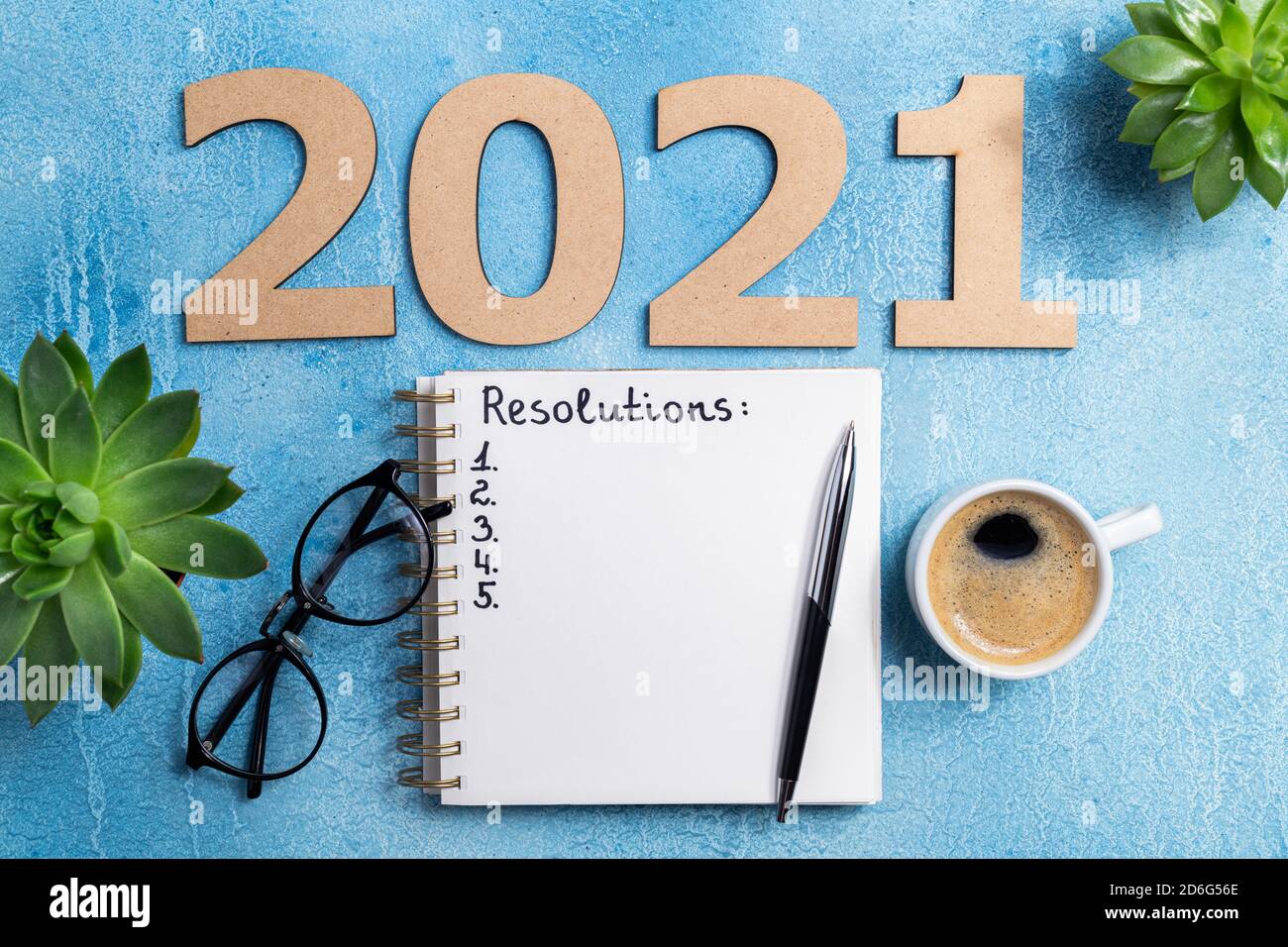 New year resolutions 2021 on desk. 2021 goals with notebook, coffee cup ...