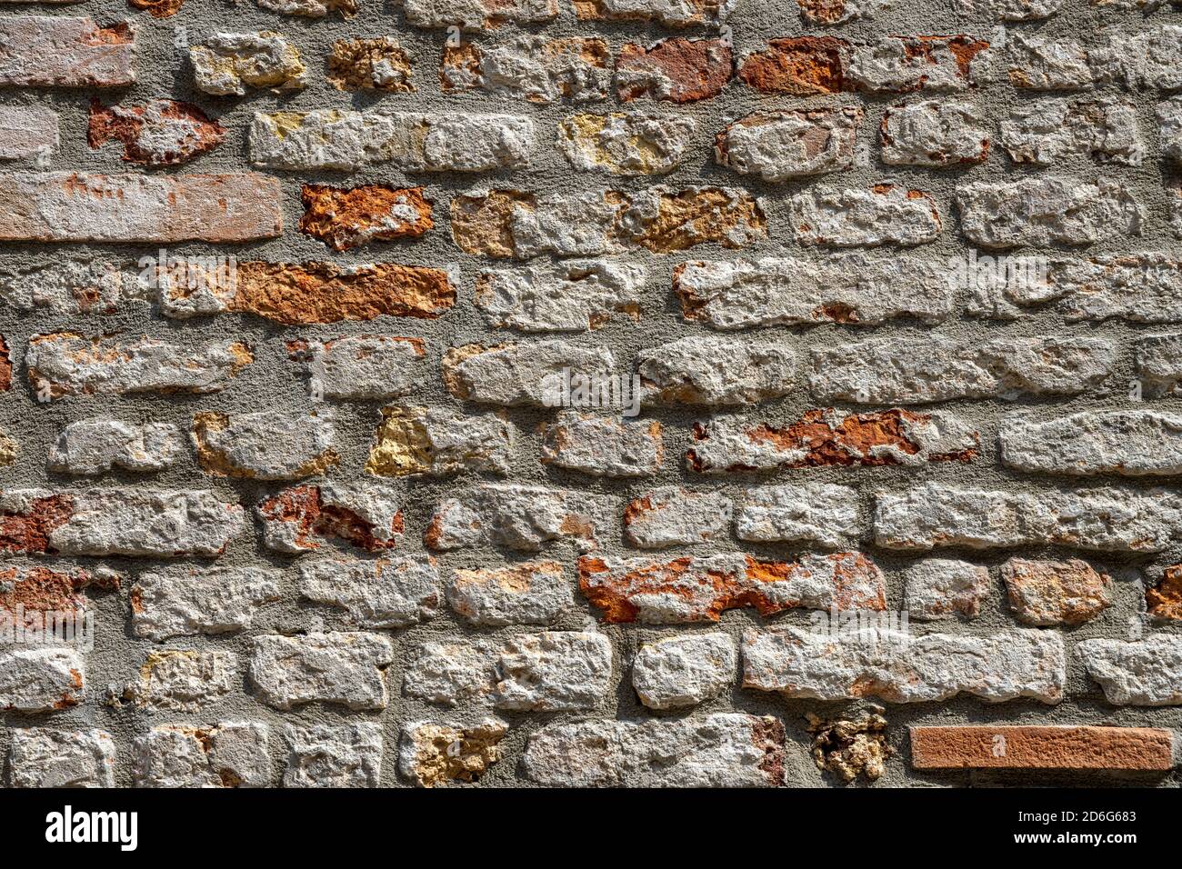 Background from a weather-beaten old red brick wall Stock Photo