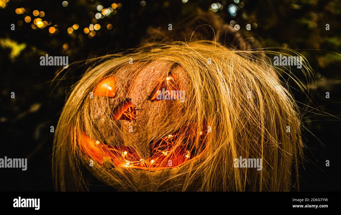 Spooky Halloween Pumpkin with blonde hair Stock Photo