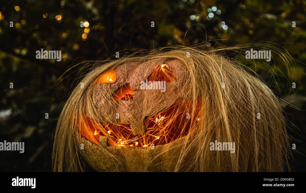 Spooky Halloween Pumpkin with blonde hair Stock Photo