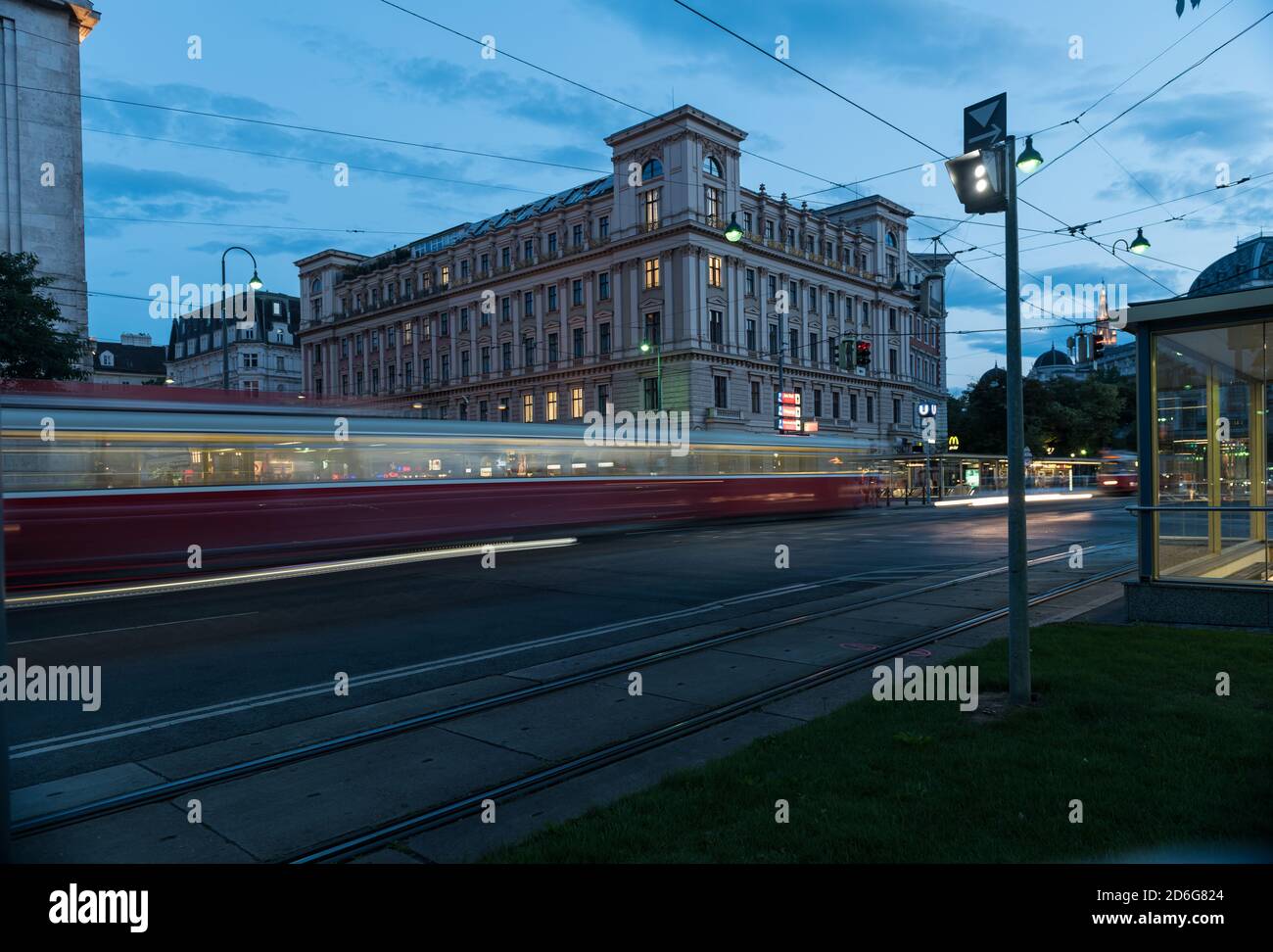 Moving tram in the evening in Vienna,Austria at a square with blue sky and yellow lights. Stock Photo