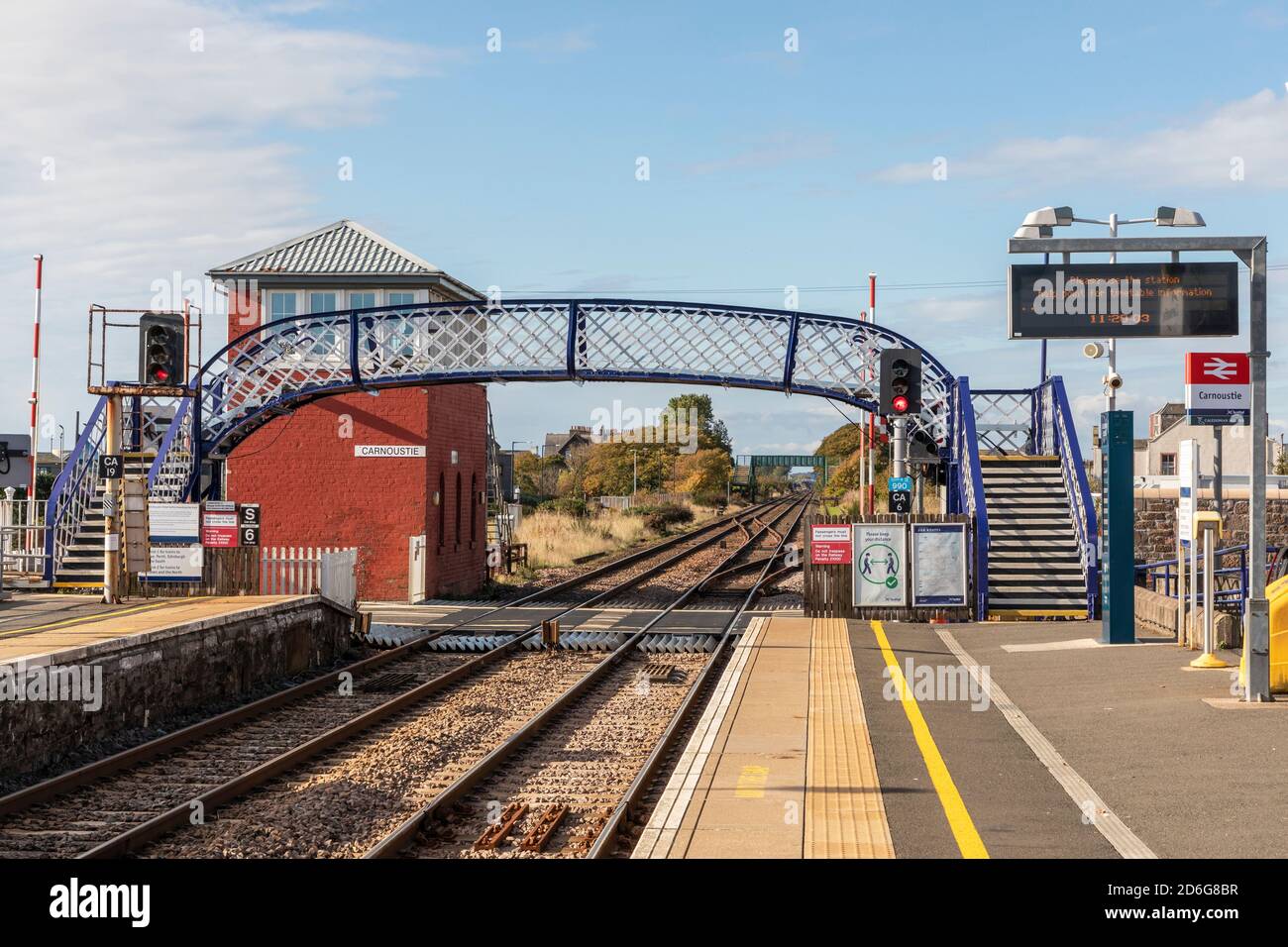 Carnoustie railway station with iron footbridge and old fashioned signal box, Carnoustie, Scotland, UK Stock Photo
