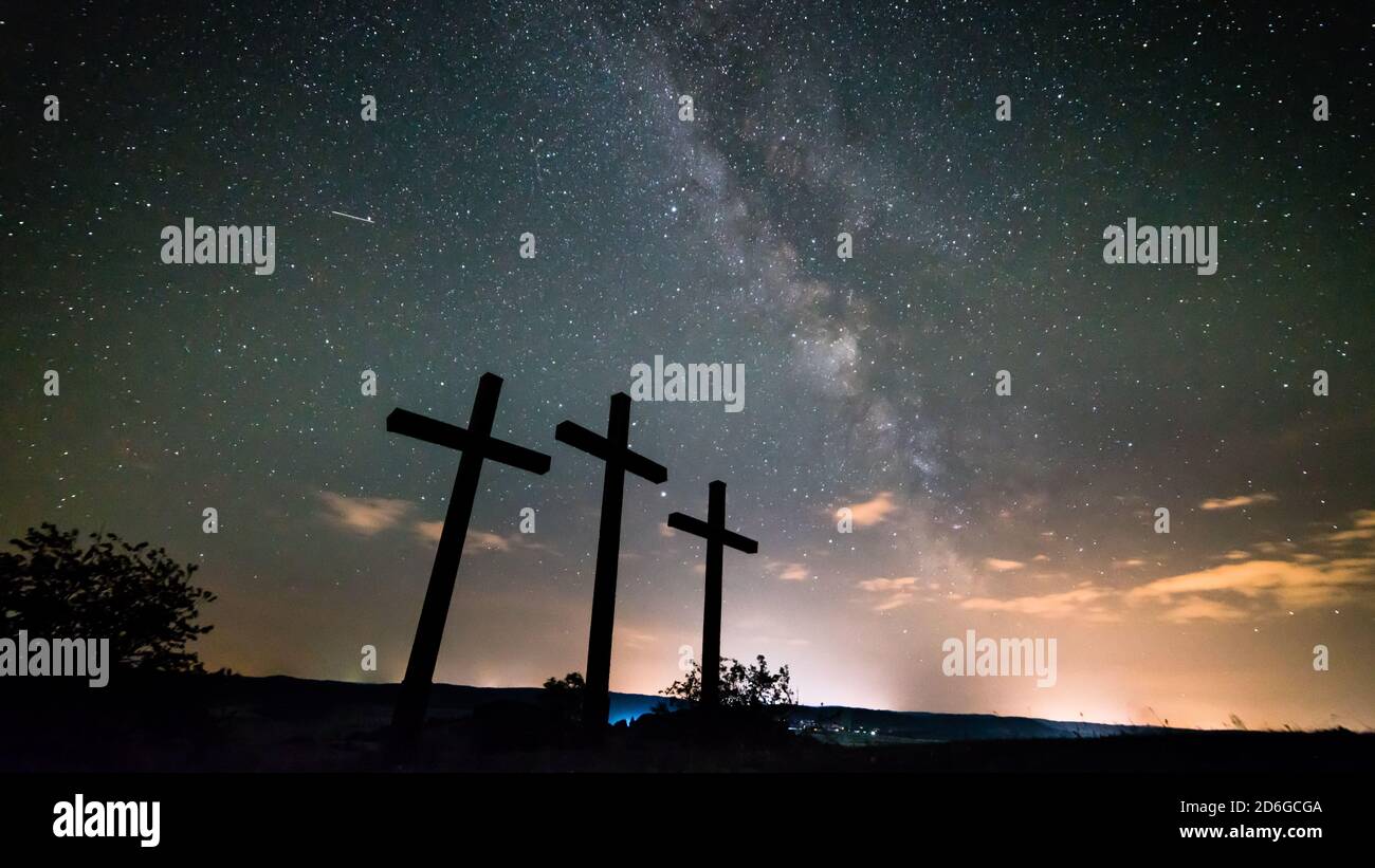 Germany, Swabian Alb, Schwäbische Alb, Three crosses under millions of stars of the milky ways galaxy by night Stock Photo