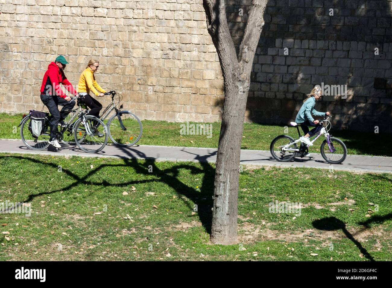 Valencia family ride a bike Turia park trail city park people cycle path Spain footpath Stock Photo