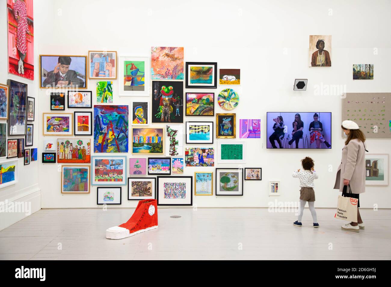 EDITORIAL USE ONLY Young artists and visitors view works at the opening ...