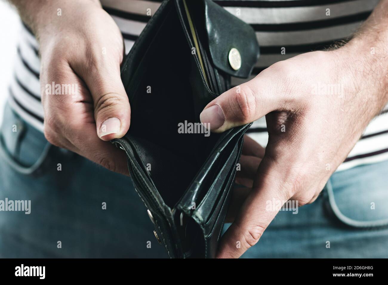 Man's hand holding an empty black wallet Stock Photo