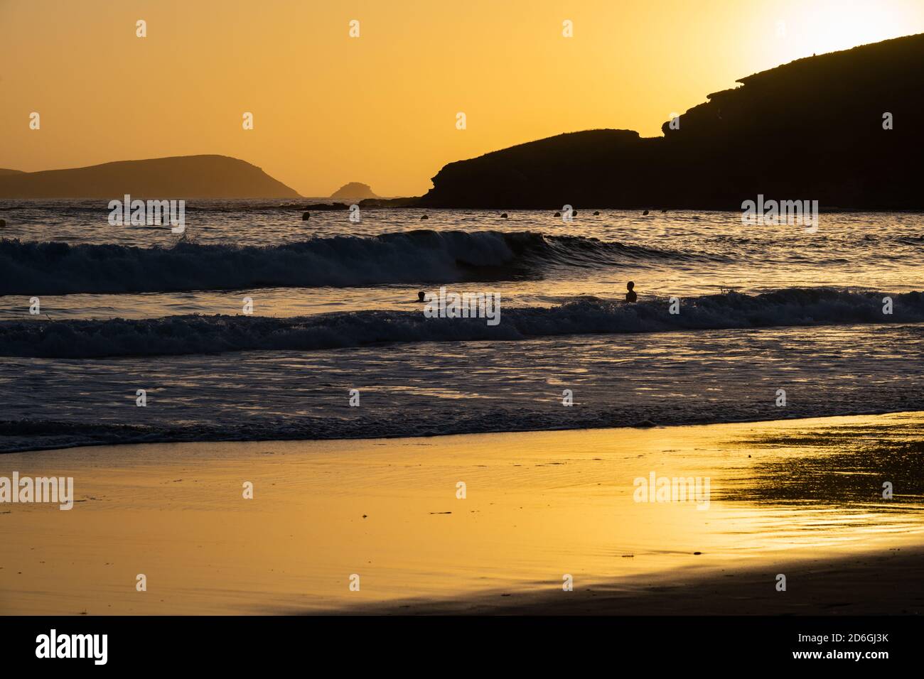 Golden sunset reflected on the shallow water on a lonely beach in Galicia, Spain. Stock Photo