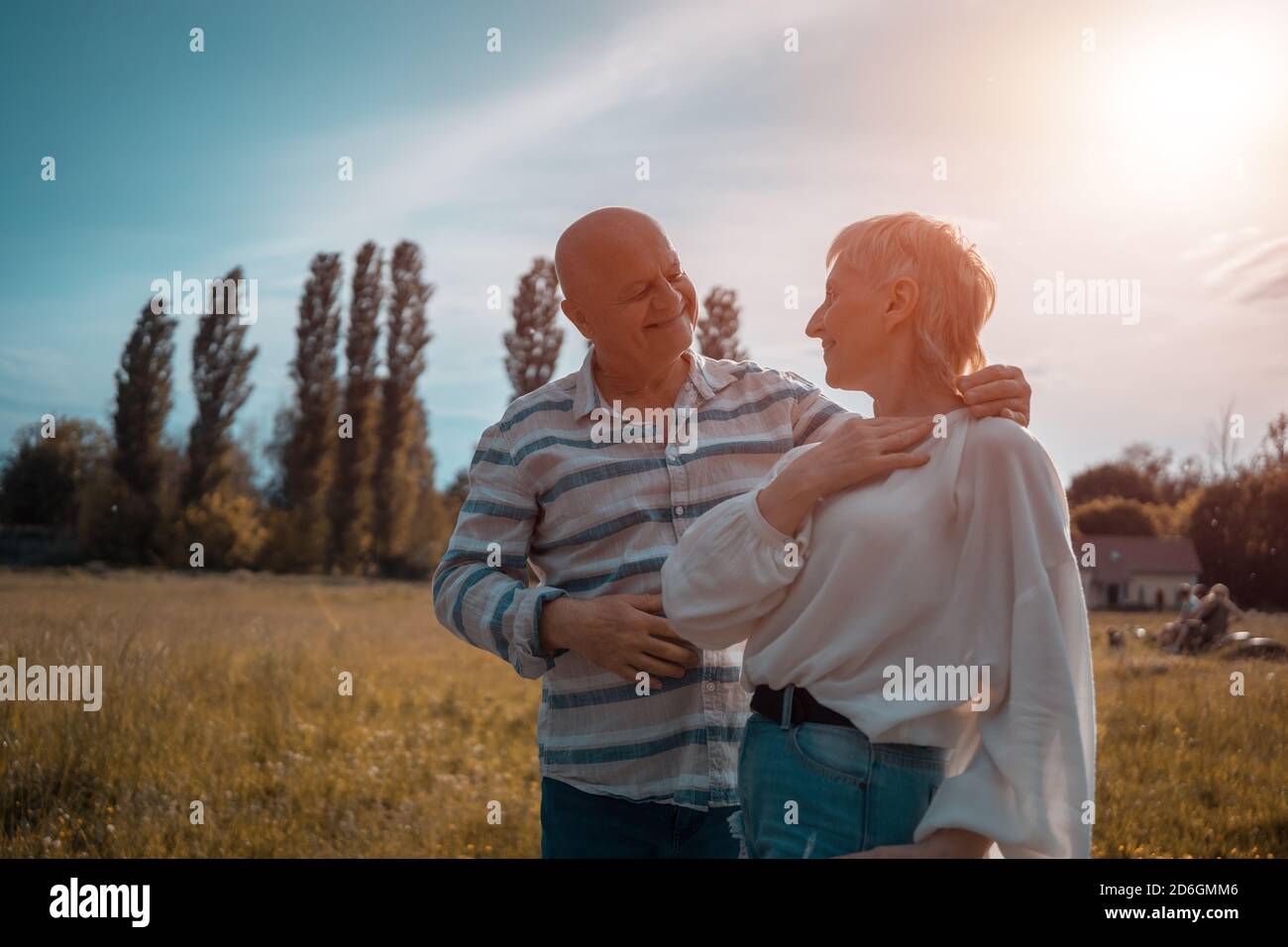 happy senior couple dating, hugging and kissing outdoor at sunset Stock Photo