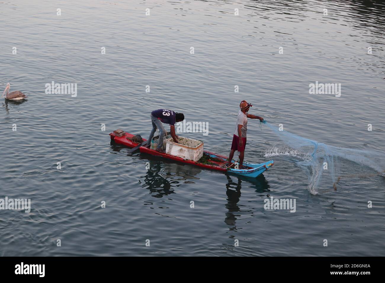 Chennai, Tamilnadu, India. Oct 18 , 2020.Fisherman throws nets into the water to catch fish from the boat Stock Photo