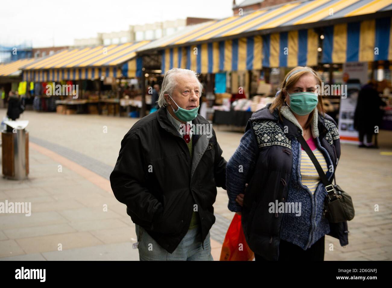 Shoppers wearing protective face masks walk in the Market Place, Dudley, in the West Midlands. Dudley may join other parts of the Black Country and Birmingham in Tier 2 of coronavirus restrictions. Stock Photo