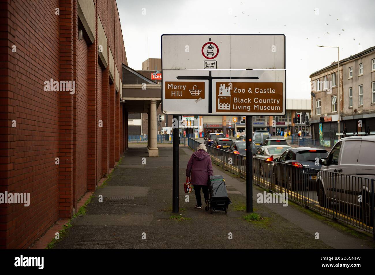 A woman walks through Dudley in the West Midlands. Dudley may join other parts of the Black Country and Birmingham in Tier 2 of coronavirus restrictions. Stock Photo