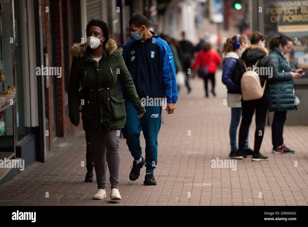Shoppers wearing protective face masks walk along High Street, Dudley