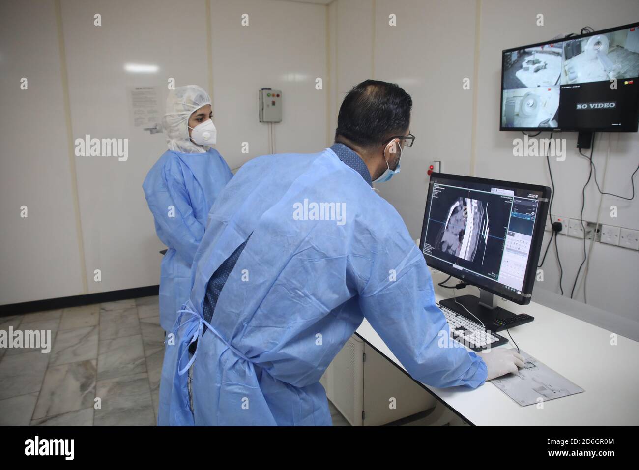 Baghdad. 17th Oct, 2020. Dr. Mohammed Abdul-Hussein (R) and CT technician Hanan Jamal examine lung images at al-Shifaa Center in Baghdad, Iraq, Oct. 12, 2020. In a specialized COVID-19 hospital in Iraqi capital of Baghdad, a Chinese-donated CT scan, mobile X-ray equipment, and other medical supplies are saving lives in the front-line battle against the COVID-19 pandemic. Already 400 patients have benefited from the important medical donation. TO GO WITH 'Spotlight: Chinese-donated CT scan, mobile X-ray save lives in specialized COVID-19 hospital in Iraq' Credit: Xinhua/Alamy Live News Stock Photo