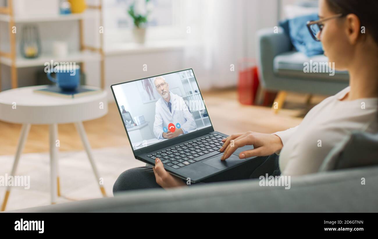 Young Girl Sick at Home Using Laptop Computer to Talk to Her Doctor via ...