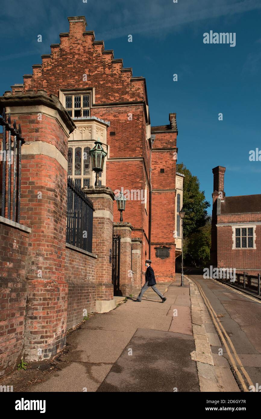 Harrow School building and a passing by young student, Greater London, UK Stock Photo