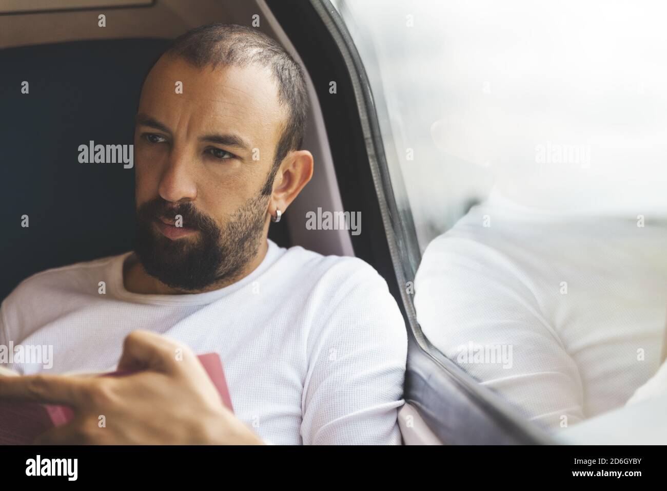 Closeup shot of a traveler man on train reading a book Stock Photo