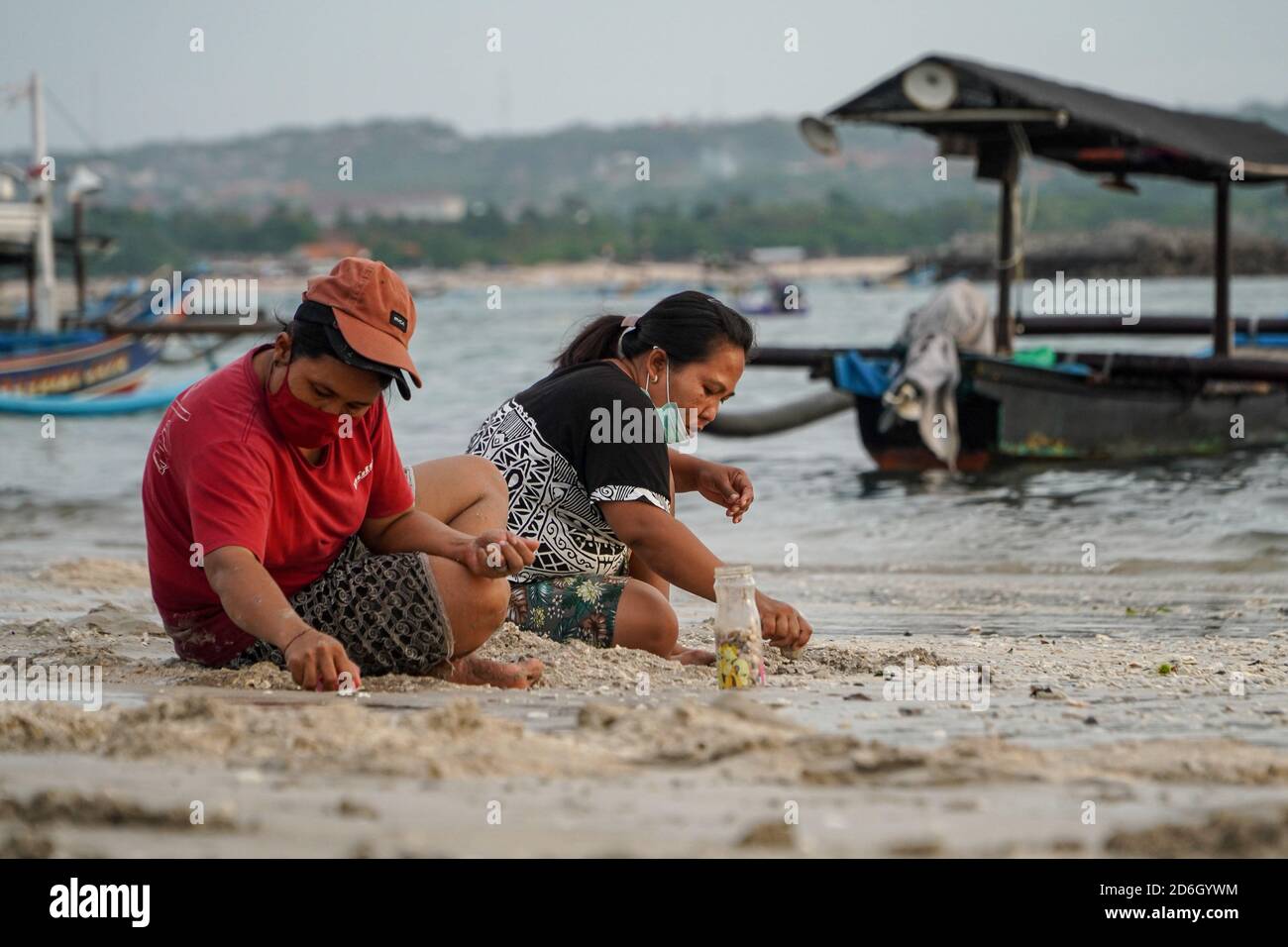 Badung, Bali, Indonesia. 17th Oct, 2020. Women collecting dead shells ...