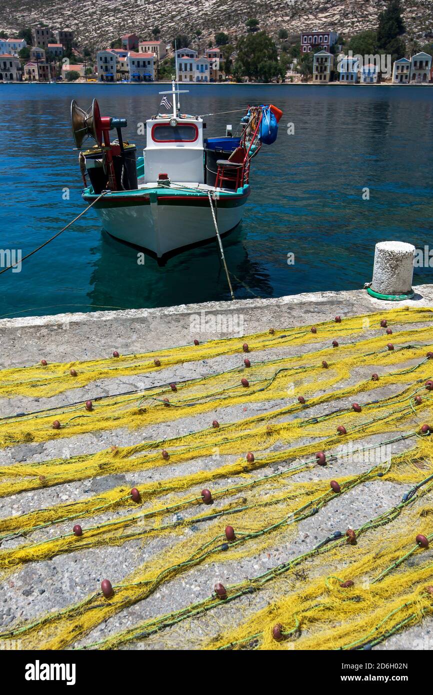 Fishing nets sit adjacent to the harbour on the Greek island of  Kastellorizo, otherwise known as Meis island Stock Photo - Alamy