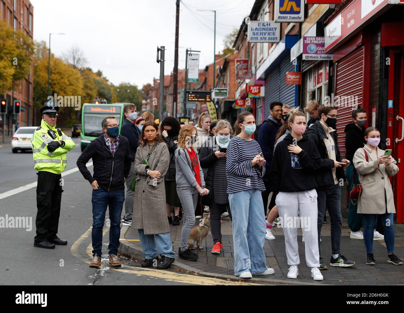 Nottingham, Nottinghamshire, UK. 17th October 2020. people look at a piece of work by graffiti artist Banksy. The work, outside a beauty salon, shows a girl hula-hooping with a bicycle tyre next to a bicycle that is missing its back wheel. Credit Darren Staples/Alamy Live News. Stock Photo