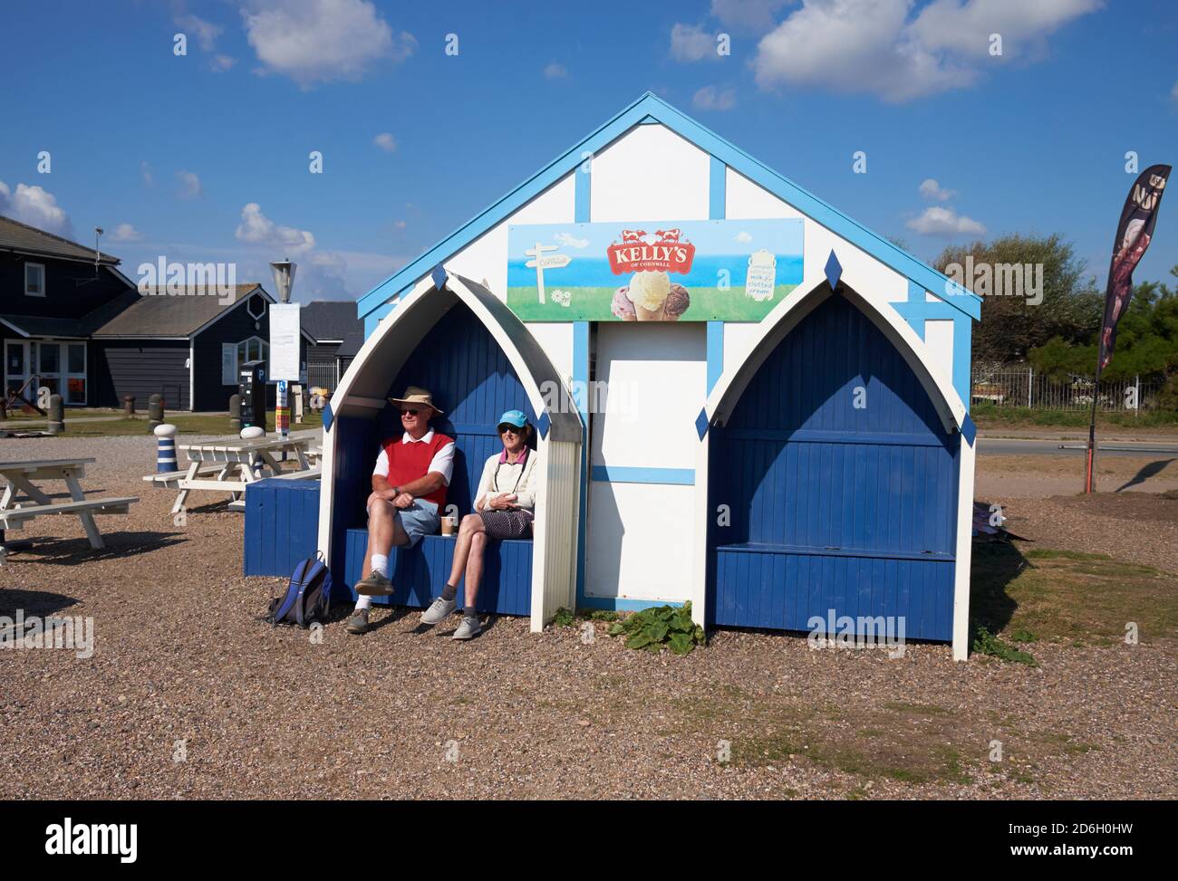 A middle aged couple enjoying a coffee at the back of a refreshment stall near the Alfred Corry lifeboat museum, Southwold harbour, Suffolk, UK. Stock Photo