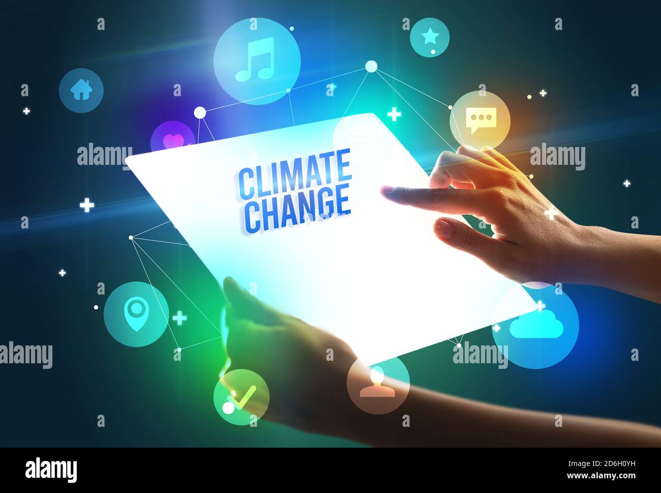 Holding futuristic tablet with CLIMATE CHANGE inscription, new technology concept Stock Photo