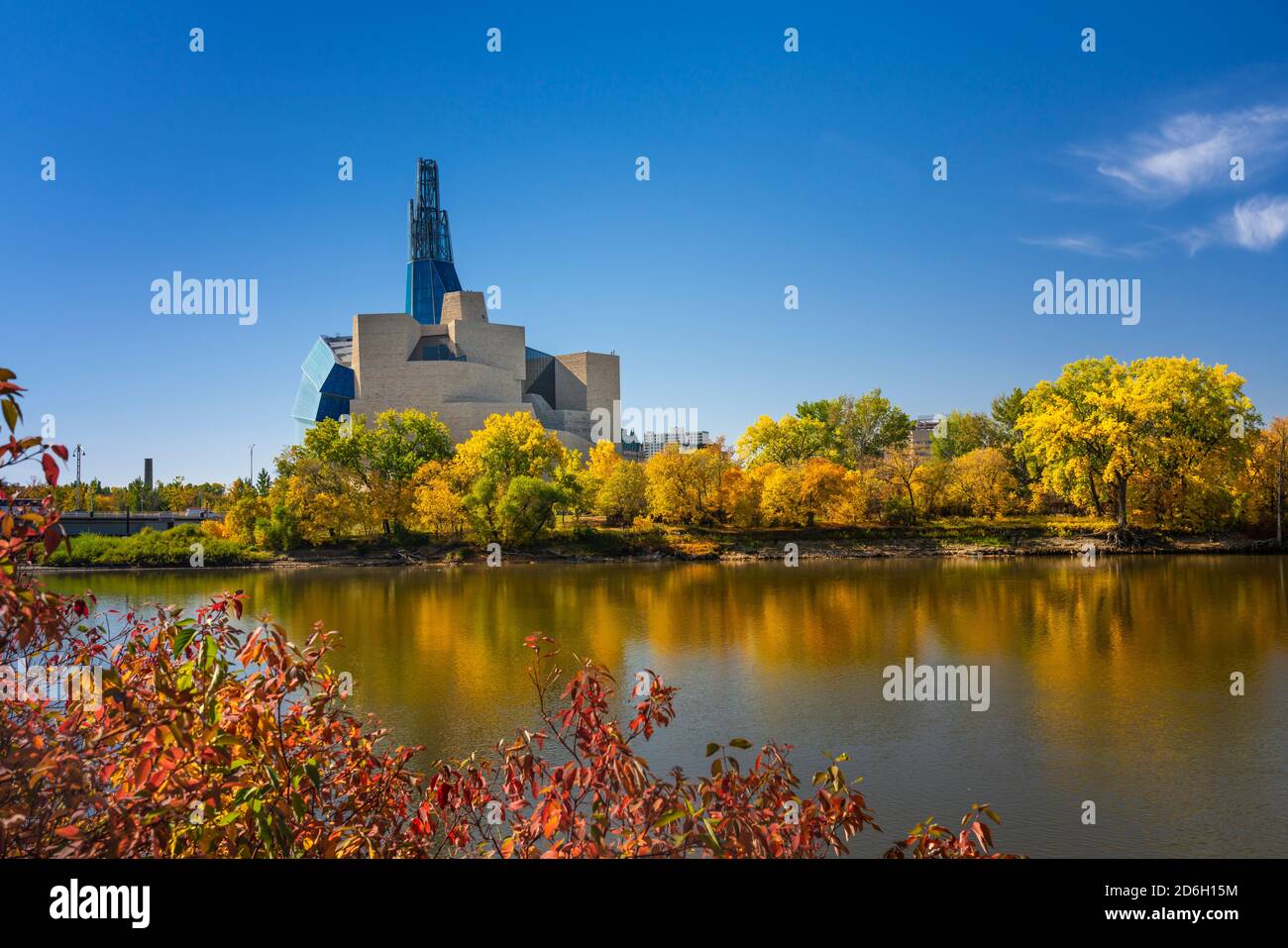 The Canadian Museum for Human Rights with the Red River and fall foliage color in Winnipeg, Manitoba, Canada. Stock Photo